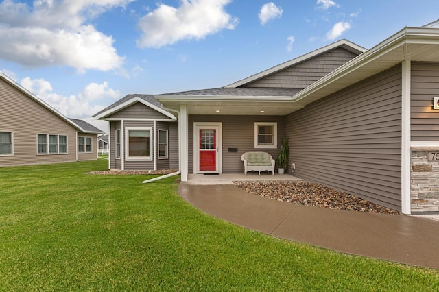 755 Escalade Ln SE, Owatonna, MN 55060 - doorway to property with a yard and roof with shingles