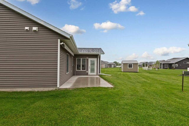 755 Escalade Ln SE, Owatonna, MN 55060 - view of grassy yard featuring a patio and a storage shed