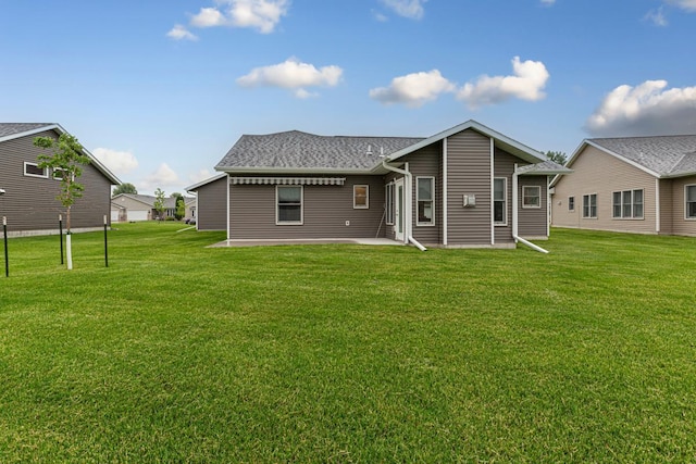 755 Escalade Ln SE, Owatonna, MN 55060 - rear view of property with a lawn, a patio, and a shingled roof