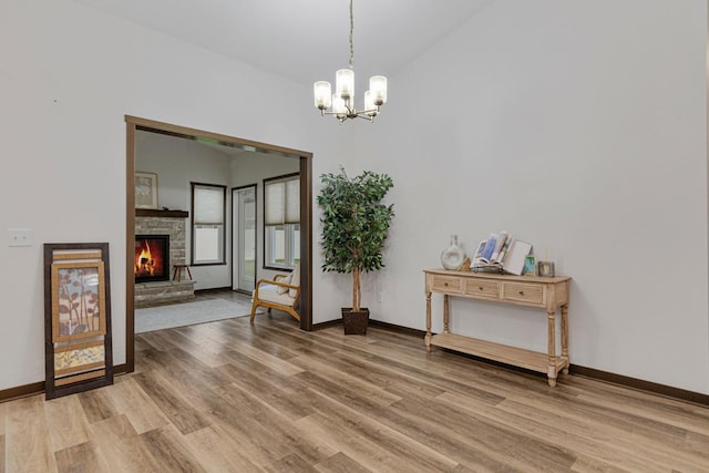 755 Escalade Ln SE, Owatonna, MN 55060 - dining space with a chandelier, light wood-style floors, vaulted ceiling, and a fireplace