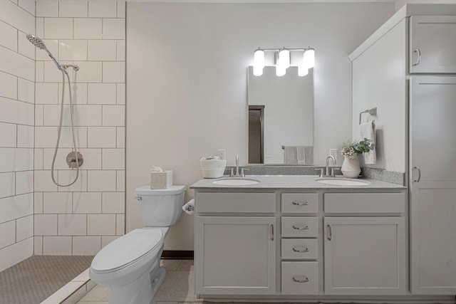 755 Escalade Ln SE, Owatonna, MN 55060 - bathroom featuring double vanity, tiled shower, and tile patterned flooring