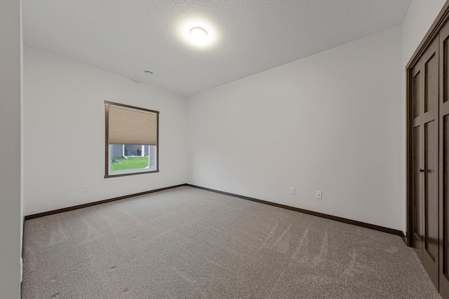 755 Escalade Ln SE, Owatonna, MN 55060 - unfurnished bedroom with carpet flooring and a textured ceiling