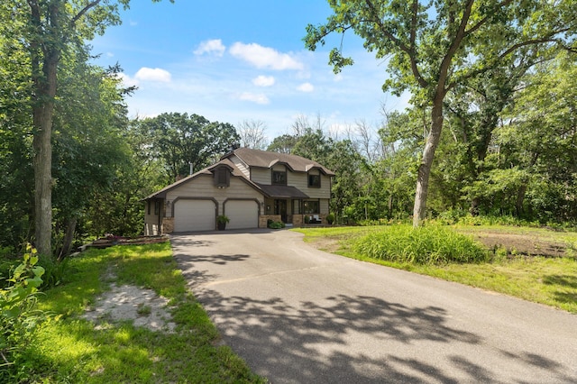 17208 Woodbine St NW, Andover, MN 55304 - view of front of property featuring driveway, a garage, and stone siding