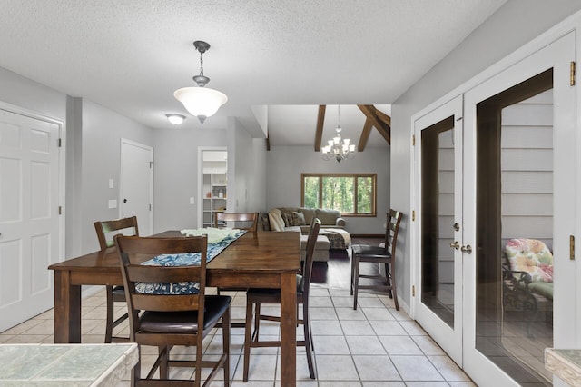 17208 Woodbine St NW, Andover, MN 55304 - dining area featuring light tile patterned floors, french doors, a textured ceiling, and a chandelier
