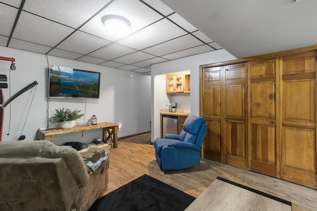 17208 Woodbine St NW, Andover, MN 55304 - living room featuring light wood-type flooring, a drop ceiling, and bar area