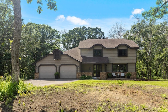 17208 Woodbine St NW, Andover, MN 55304 - view of front of home featuring brick siding, driveway, an attached garage, and roof with shingles