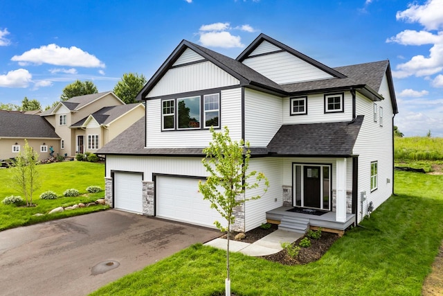 13566 Birdsong Path, Rosemount, MN 55068 - view of front of home featuring a shingled roof, asphalt driveway, a garage, a front yard, and stone siding