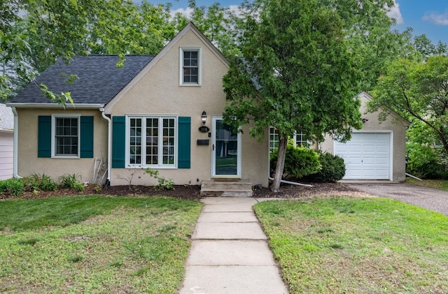 3826 Adair Ave N, Crystal, MN 55422 - view of front facade with a front lawn, stucco siding, a garage, and driveway