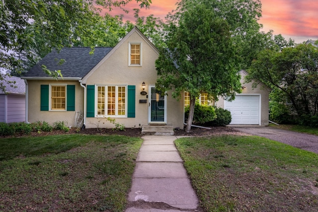 3826 Adair Ave N, Crystal, MN 55422 - view of front facade with stucco siding, asphalt driveway, a garage, and a front lawn