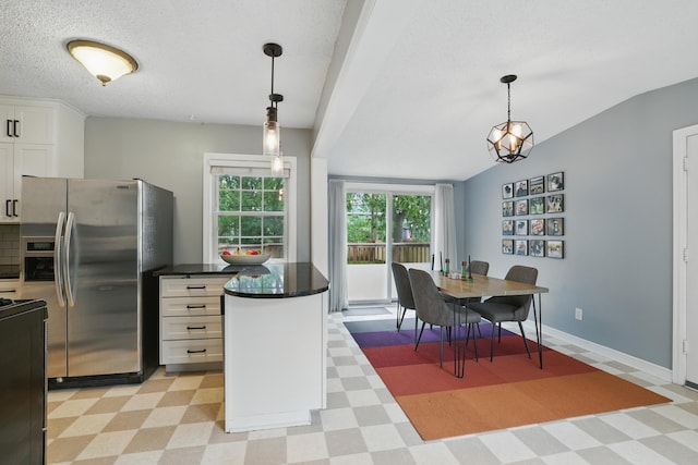 3826 Adair Ave N, Crystal, MN 55422 - kitchen featuring stainless steel fridge, light floors, white cabinetry, dark countertops, and range with electric stovetop