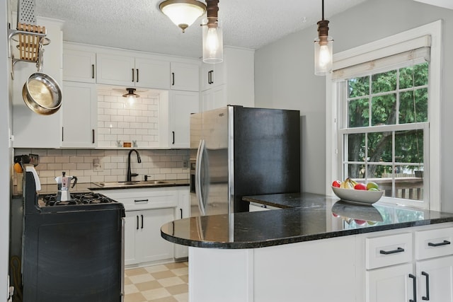 3826 Adair Ave N, Crystal, MN 55422 - kitchen featuring gas stove, light flooring, white cabinetry, backsplash, and decorative light fixtures