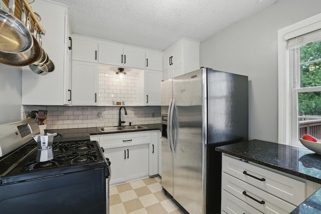 3826 Adair Ave N, Crystal, MN 55422 - kitchen featuring range with gas cooktop, stainless steel fridge with ice dispenser, light floors, white cabinetry, and a textured ceiling
