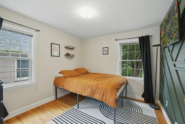 3826 Adair Ave N, Crystal, MN 55422 - bedroom featuring light wood finished floors and a textured ceiling
