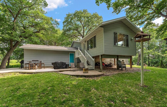 1202 Matteson St, Faribault, MN 55021 - back of house featuring a patio area, a lawn, and stairway