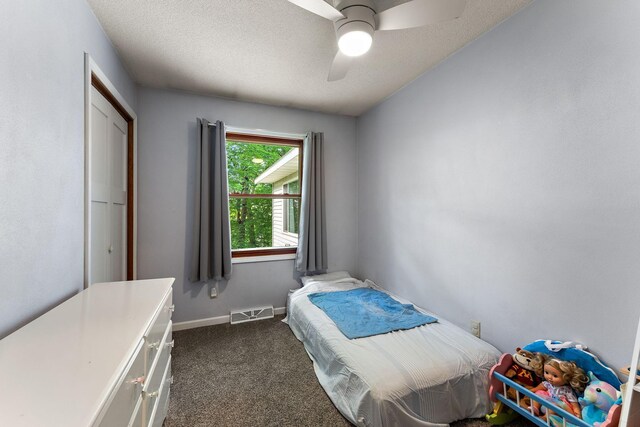1202 Matteson St, Faribault, MN 55021 - bedroom featuring dark colored carpet, ceiling fan, and a textured ceiling