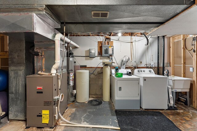 1202 Matteson St, Faribault, MN 55021 - unfinished basement with washer and dryer, electric panel, and heating unit
