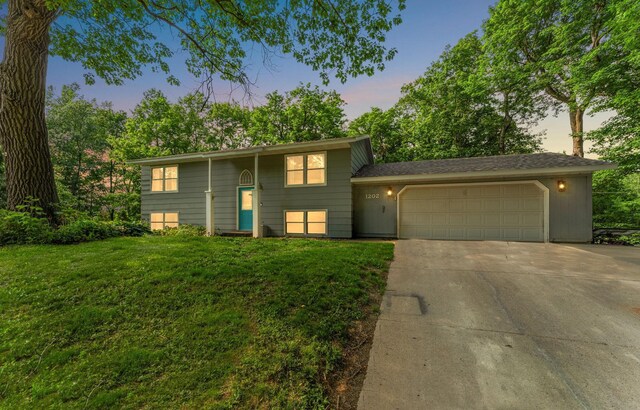 1202 Matteson St, Faribault, MN 55021 - bi-level home featuring a garage, concrete driveway, and a front yard