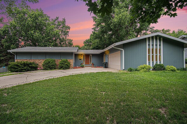 201 Elm St, Luverne, MN 56156 - mid-century home featuring a front lawn, a garage, and driveway