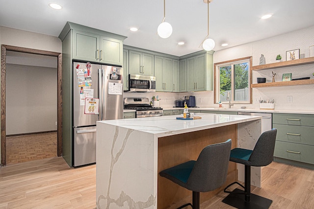 201 Elm St, Luverne, MN 56156 - kitchen featuring appliances with stainless steel finishes, green cabinets, light wood finished floors, decorative backsplash, and recessed lighting
