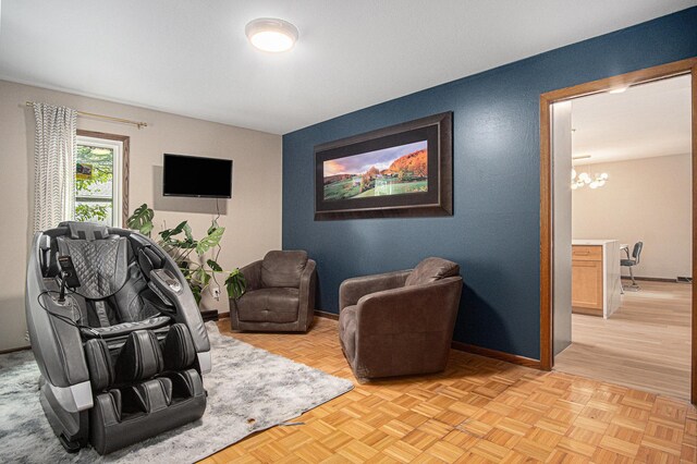 201 Elm St, Luverne, MN 56156 - sitting room featuring a chandelier and baseboards