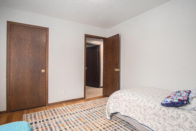 201 Elm St, Luverne, MN 56156 - bedroom featuring light wood-style floors and a textured ceiling
