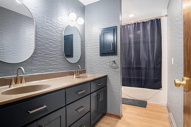 201 Elm St, Luverne, MN 56156 - full bath with wood finished floors, double vanity, and shower / bathtub combination with curtain