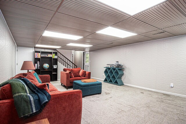 201 Elm St, Luverne, MN 56156 - living area featuring a textured wall, stairs, and carpet