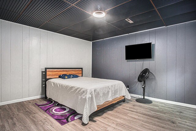 201 Elm St, Luverne, MN 56156 - bedroom featuring wood finished floors and wooden walls