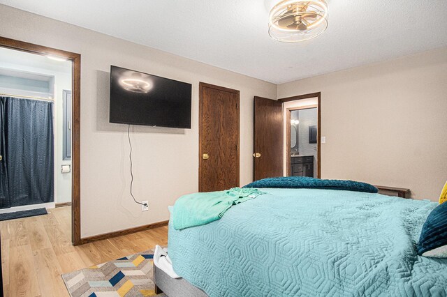 201 Elm St, Luverne, MN 56156 - bedroom featuring light wood-style flooring and ensuite bath