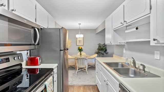 4397 Wilshire Blvd # E305, Mound, MN 55364 - kitchen with appliances with stainless steel finishes, white cabinetry, and light countertops