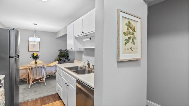 4397 Wilshire Blvd # E305, Mound, MN 55364 - kitchen with stainless steel appliances, white cabinets, light wood-type flooring, light countertops, and pendant lighting