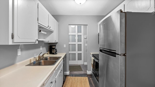 4397 Wilshire Blvd # E305, Mound, MN 55364 - kitchen featuring stainless steel appliances, white cabinetry, dark wood finished floors, and light countertops