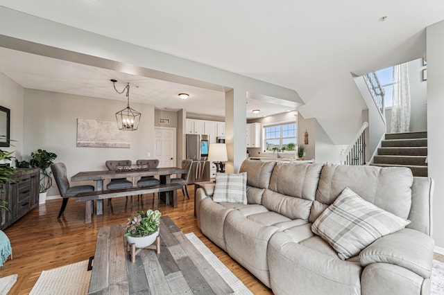 1842 Colonial Ln Unit 6, Chanhassen, MN 55317 - living room featuring stairs, light wood-type flooring, and a chandelier