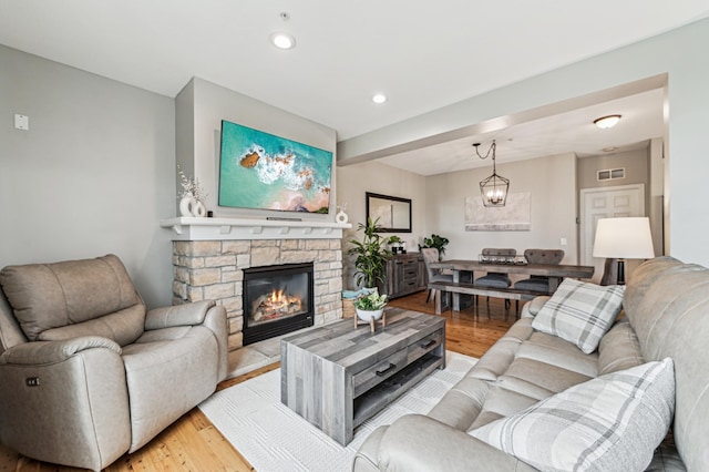 1842 Colonial Ln Unit 6, Chanhassen, MN 55317 - living room with light wood-style flooring, a fireplace, a chandelier, and recessed lighting