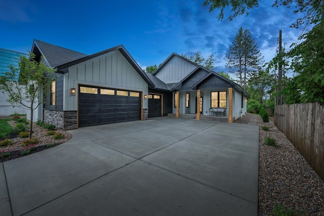 3909 54th St, Edina, MN 55424 - modern inspired farmhouse with a garage, stone siding, driveway, board and batten siding, and a porch