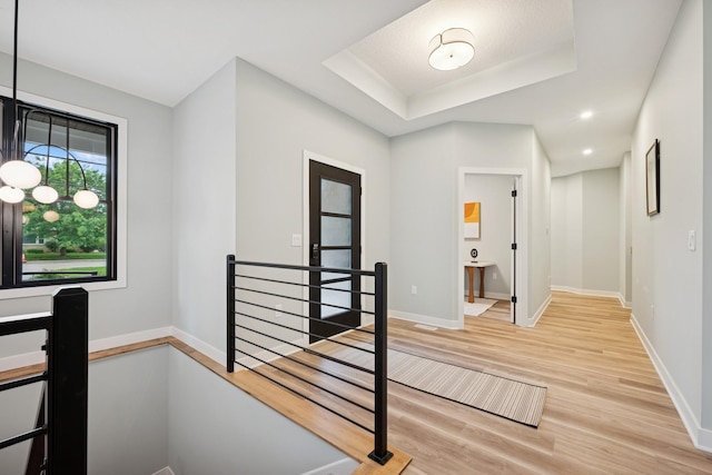 3909 54th St, Edina, MN 55424 - corridor with an upstairs landing, light wood finished floors, and a raised ceiling