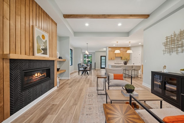 3909 54th St, Edina, MN 55424 - living room featuring light wood finished floors, a glass covered fireplace, beamed ceiling, and recessed lighting