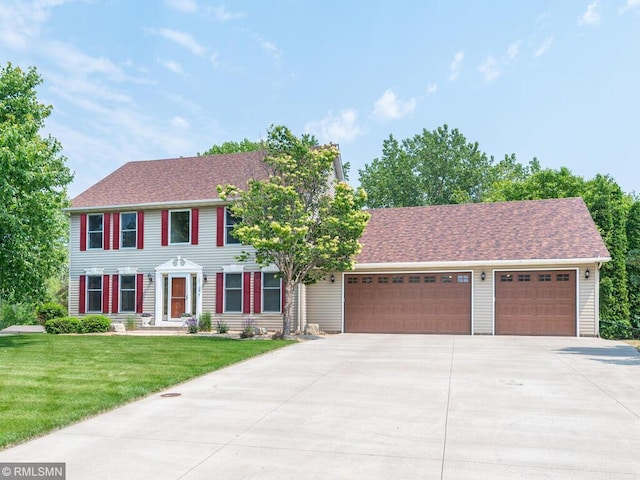 20108 Calgary Trl, Empire Twp, MN 55024 - colonial home featuring driveway, an attached garage, a front lawn, and roof with shingles