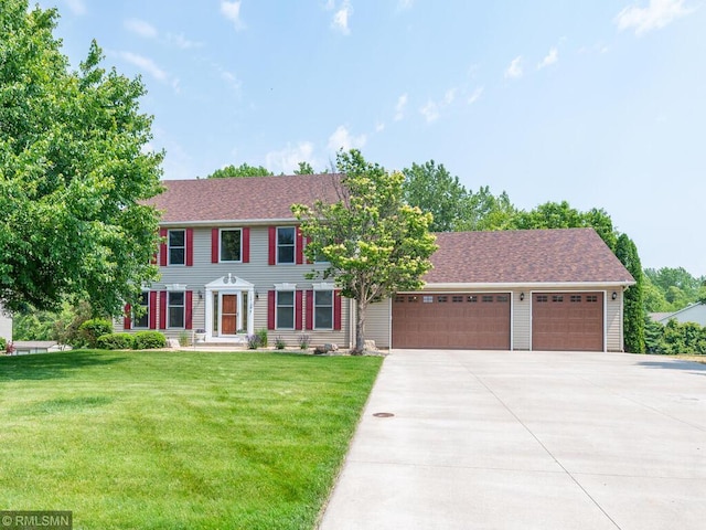 20108 Calgary Trl, Empire Twp, MN 55024 - colonial inspired home with driveway, an attached garage, a front lawn, and roof with shingles