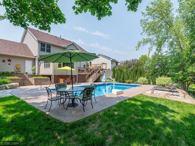 20108 Calgary Trl, Empire Twp, MN 55024 - outdoor pool with stairs, a wooden deck, a patio, a yard, and an outdoor fire pit