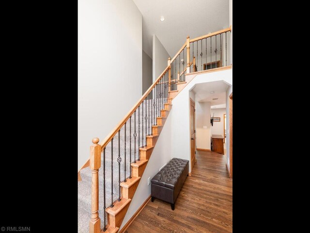 20108 Calgary Trl, Empire Twp, MN 55024 - stairway featuring wood finished floors, a towering ceiling, and recessed lighting