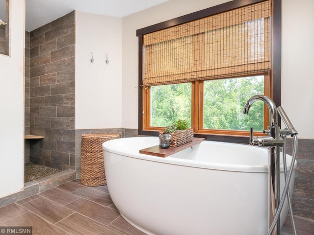 20108 Calgary Trl, Empire Twp, MN 55024 - bathroom featuring a freestanding bath, tile walls, and a tile shower