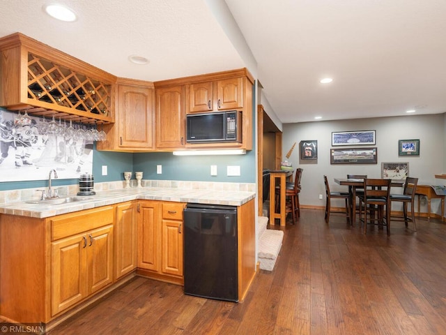 20108 Calgary Trl, Empire Twp, MN 55024 - kitchen with black microwave, tile counters, dark wood-type flooring, recessed lighting, and fridge