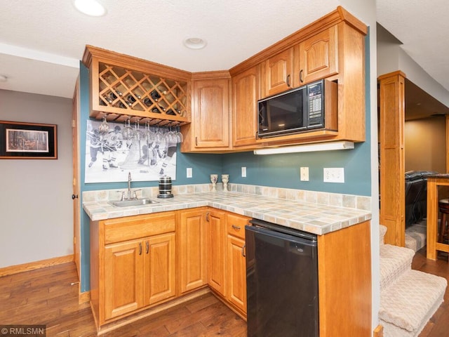 20108 Calgary Trl, Empire Twp, MN 55024 - kitchen featuring black appliances, tile counters, dark wood-style floors, and recessed lighting