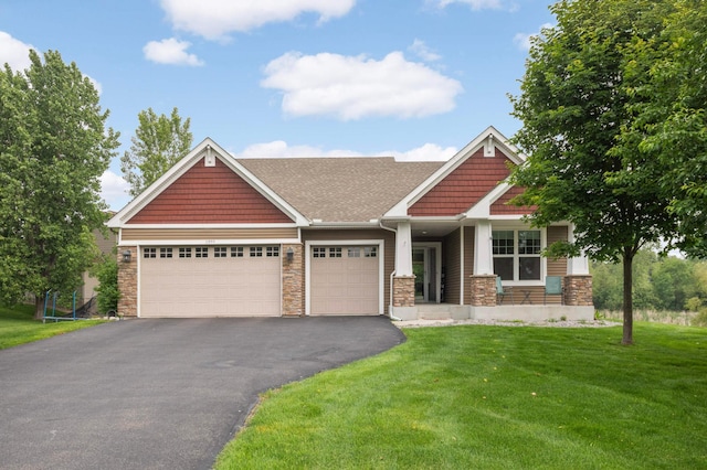 11950 75th St NE, Otsego, MN 55301 - craftsman house with stone siding, an attached garage, asphalt driveway, a front lawn, and roof with shingles