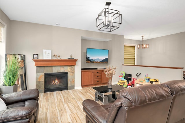 11950 75th St NE, Otsego, MN 55301 - living area with a chandelier, light wood-style flooring, and a fireplace