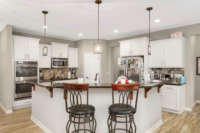 11950 75th St NE, Otsego, MN 55301 - kitchen with stainless steel appliances, decorative backsplash, light wood finished floors, and recessed lighting