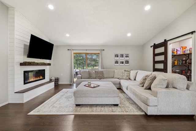 17561 Denkbar Loop, Park Rapids, MN 56470 - living room featuring a barn door, recessed lighting, wood finished floors, lofted ceiling, and a glass covered fireplace