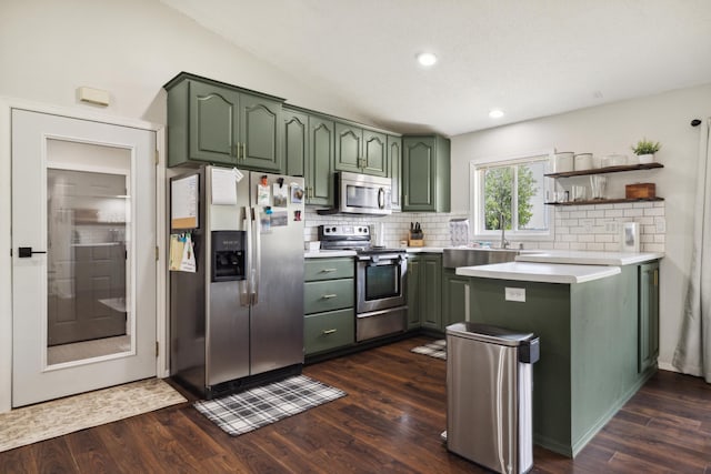 17561 Denkbar Loop, Park Rapids, MN 56470 - kitchen featuring green cabinetry, stainless steel appliances, decorative backsplash, dark wood-style flooring, and vaulted ceiling