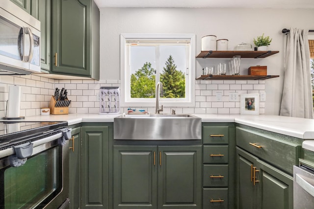 17561 Denkbar Loop, Park Rapids, MN 56470 - kitchen featuring green cabinets, stainless steel appliances, tasteful backsplash, and light countertops